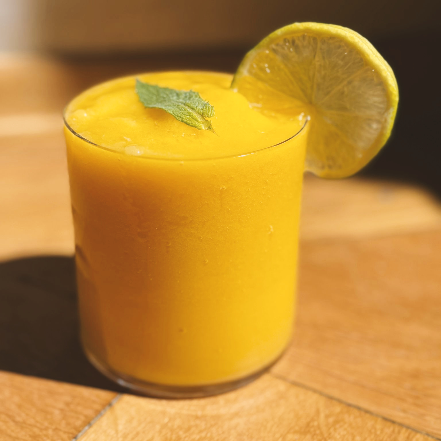 Fresh green vegetable smoothie in a minimalist glass